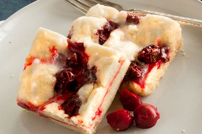 Cherry Pie Bars are easy to make and serve for dessert for Summer BBQ's!  Tart Cherries give a burst of flavor over the tender crumb bar in every bite!