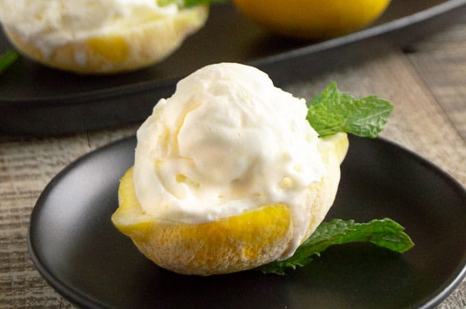 Creamy Lemon ice cream is made simply in your freezer(no-churn) with fresh homemade wholesome ingredients.  Serve them scooped on cones or in lemon boats for impressive easy entertaining!