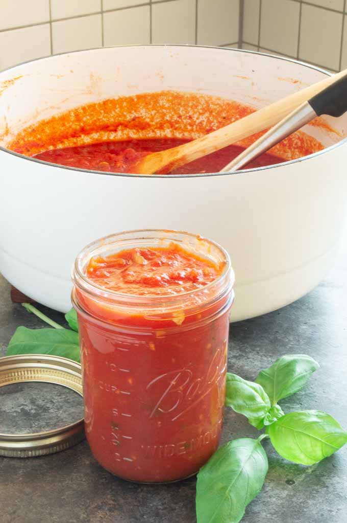 Pot of marinara sauce as it is filling jar to store