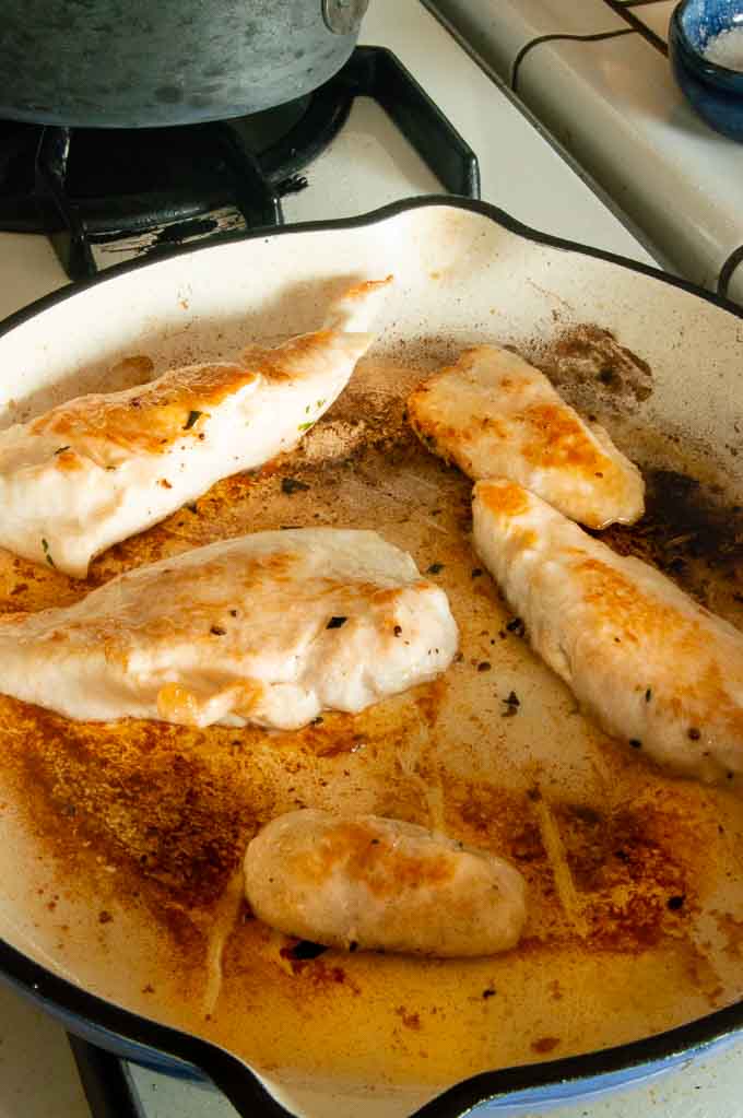 Pan searing the chicken in a skillet on the stovetop