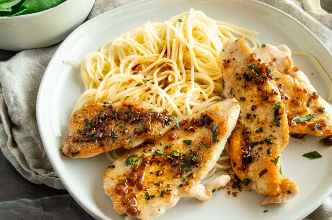 Golden brown seared Stove Top Chicken seasoned with fresh tarragon, with a vermouth butter sauce spooned over the top is a simple, one pan dinner that you can have on the table in less than 20 minutes!