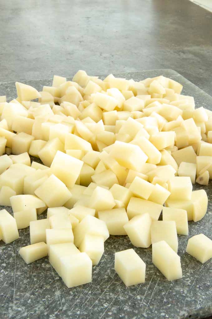 1/2 " dice potatoes on a cutting board