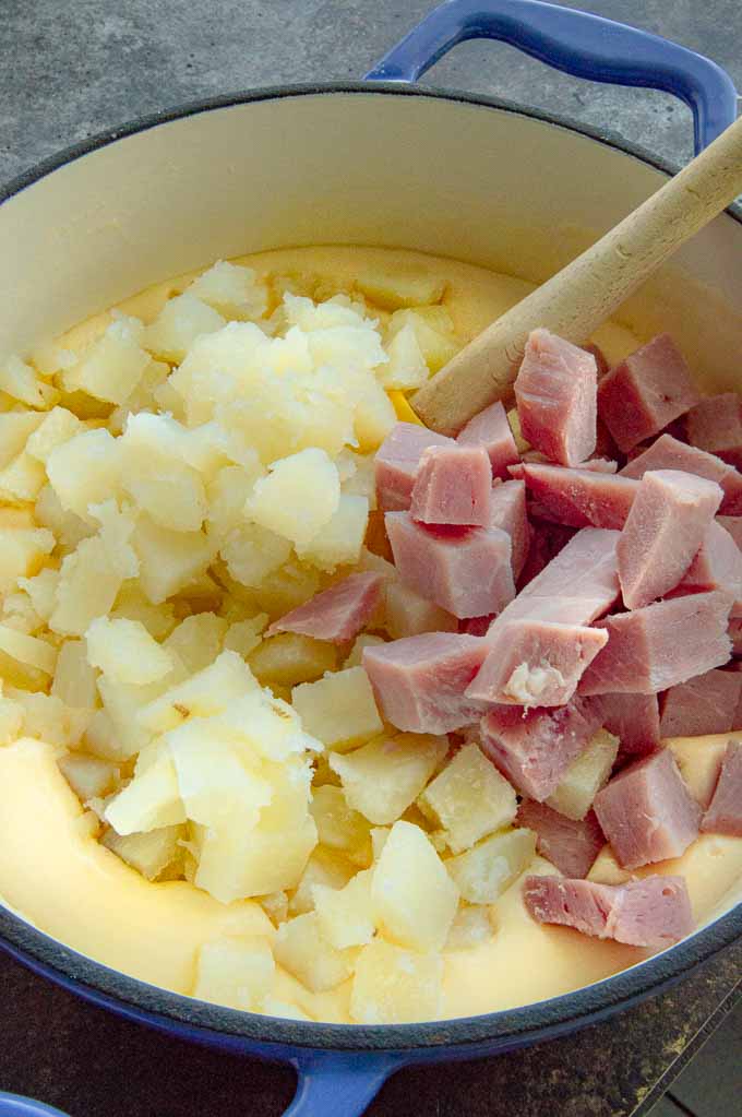 potatoes, cheese sauce and diced ham ready to be stirred for the hot dish