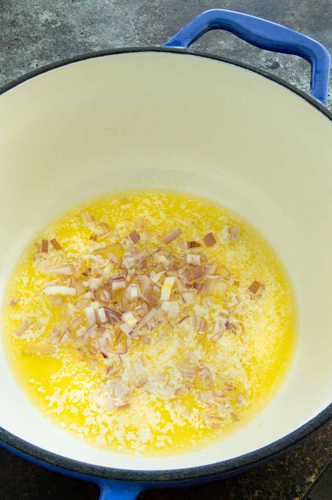 onions and butter being sauted in a pot