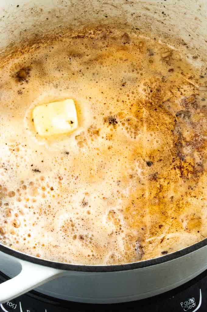 melting butter in mushroom broth pan