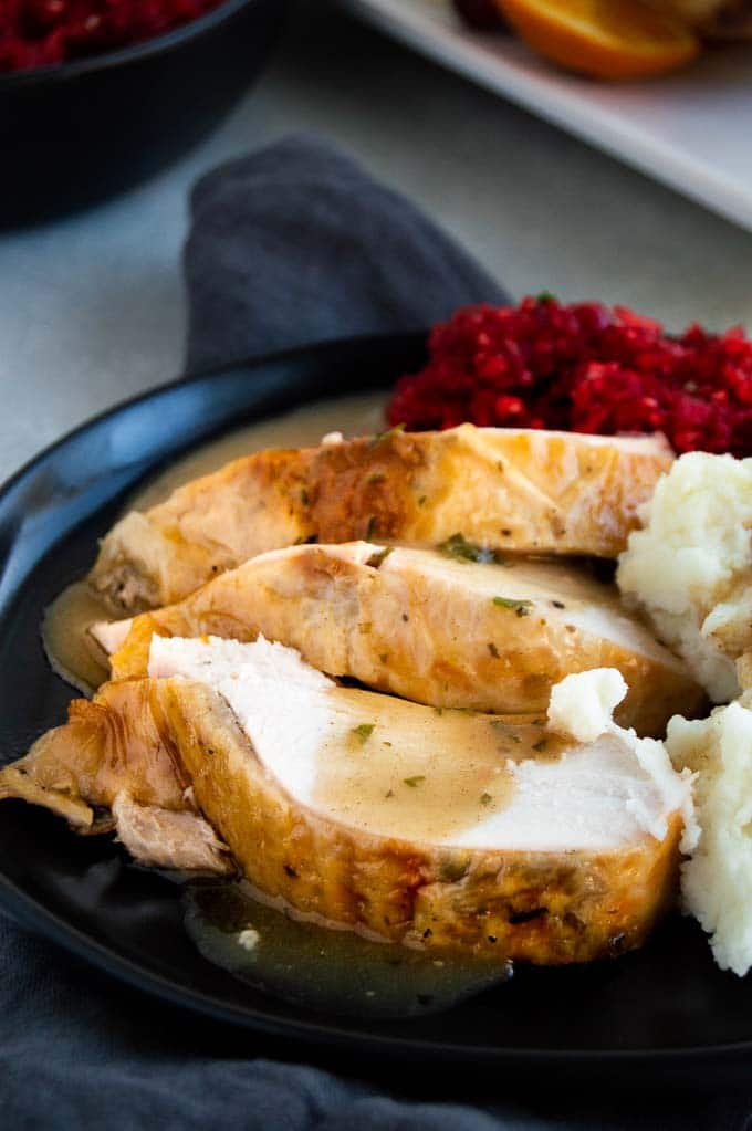 thick slices of turkey with gravy on a plate