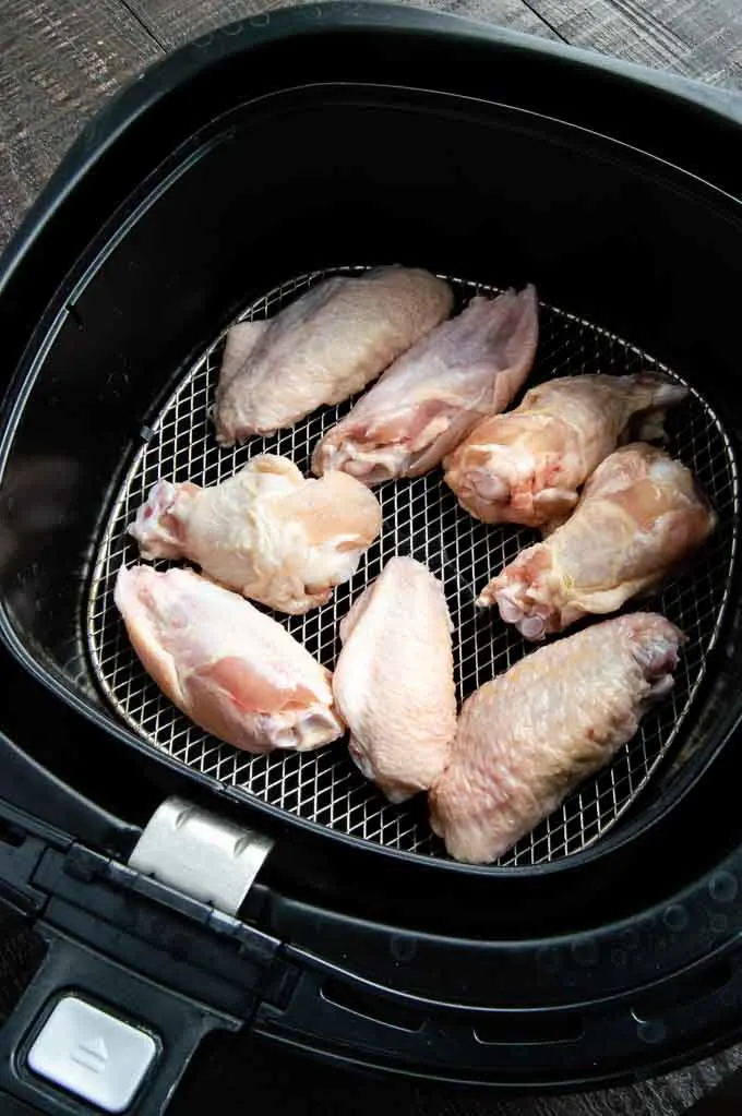 raw chicken being placed in the Airfryer