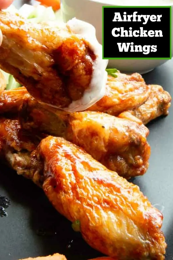 dipping into sauce for a juicy chicken wing