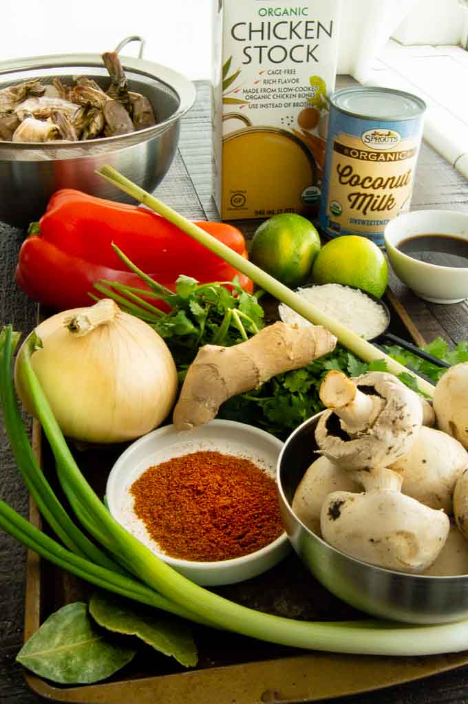 all the ingredients on a tray for shrimp soup in a thai broth