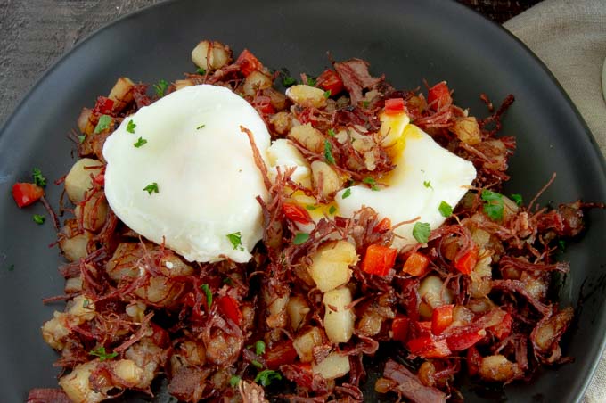 Perfect poached eggs on top of cooked hash