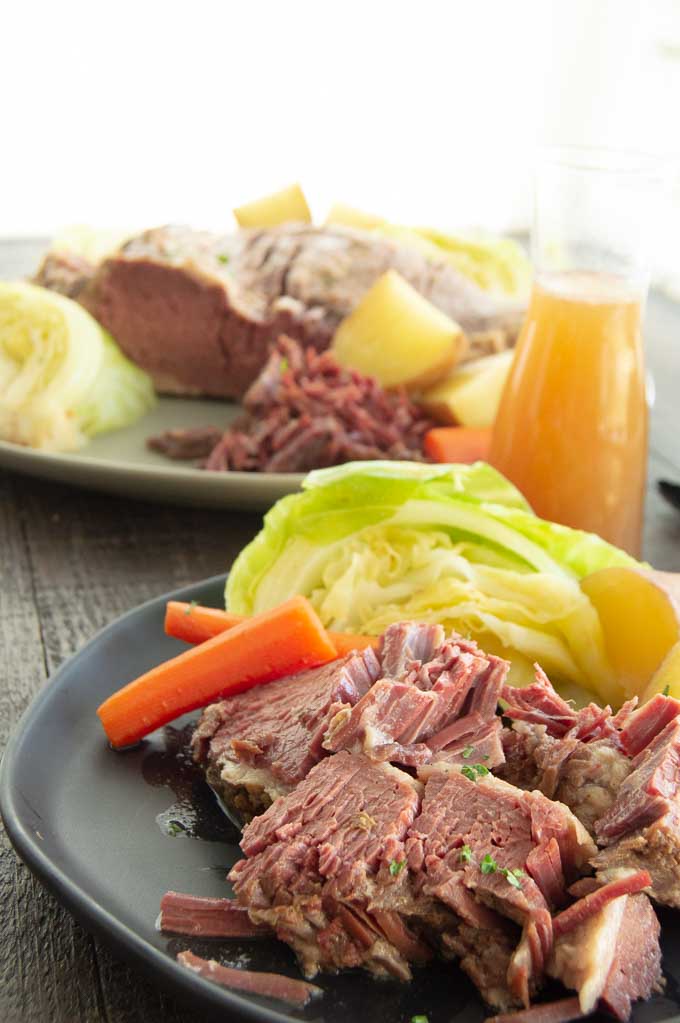 Dinner table with corned beef brisket on it.