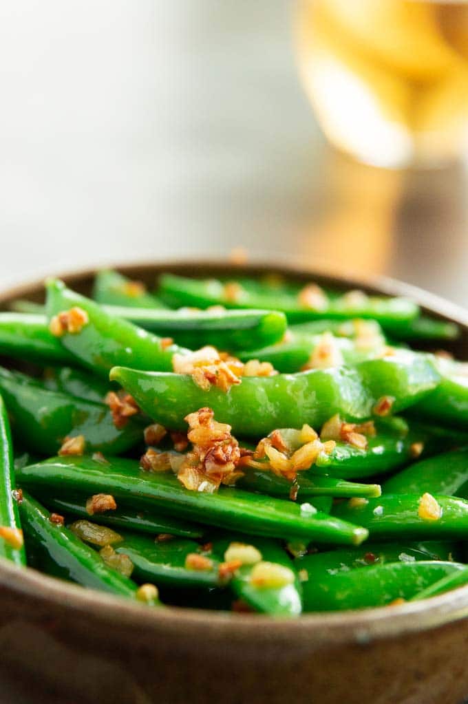 crispy garlic atop healthy sugar snap peas