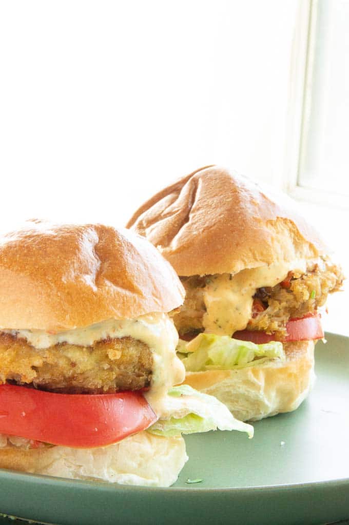 two crab cake sliders on a green plate