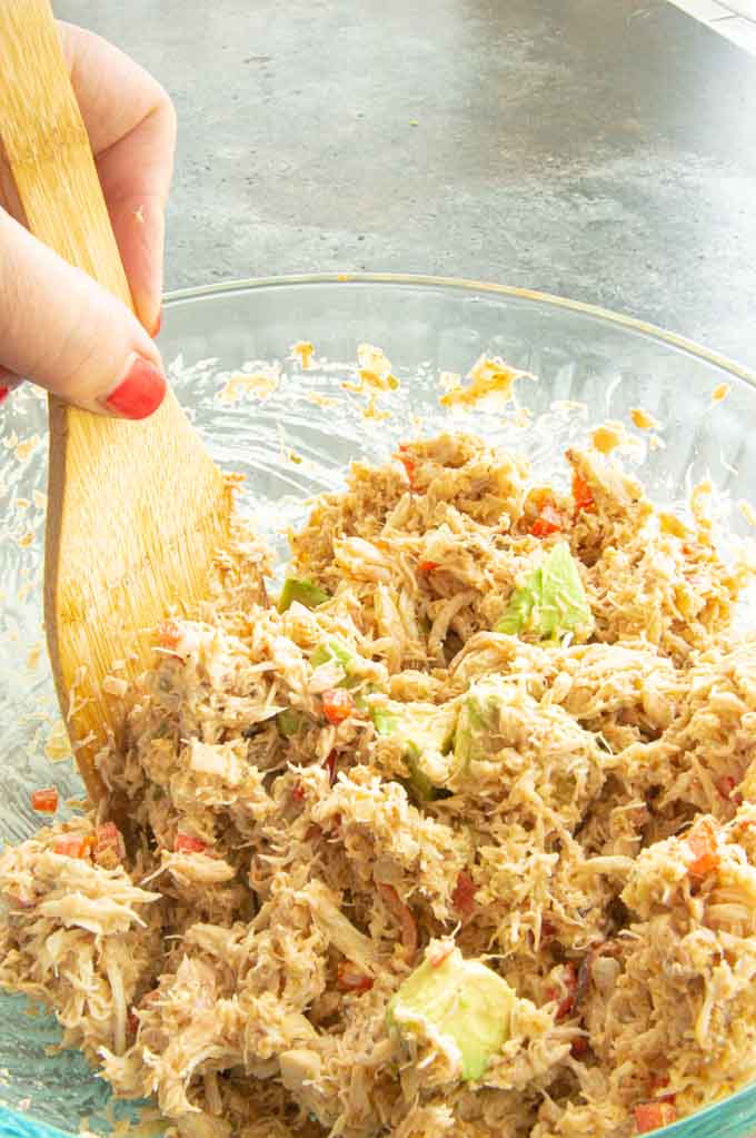 Wooden spoon stirring the crab cake mixture