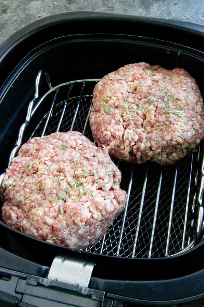 Lamb burger patties in an air fryer basket