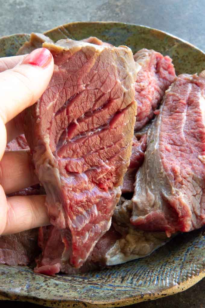 1/4" slices of flap meat being shown cut against the grain