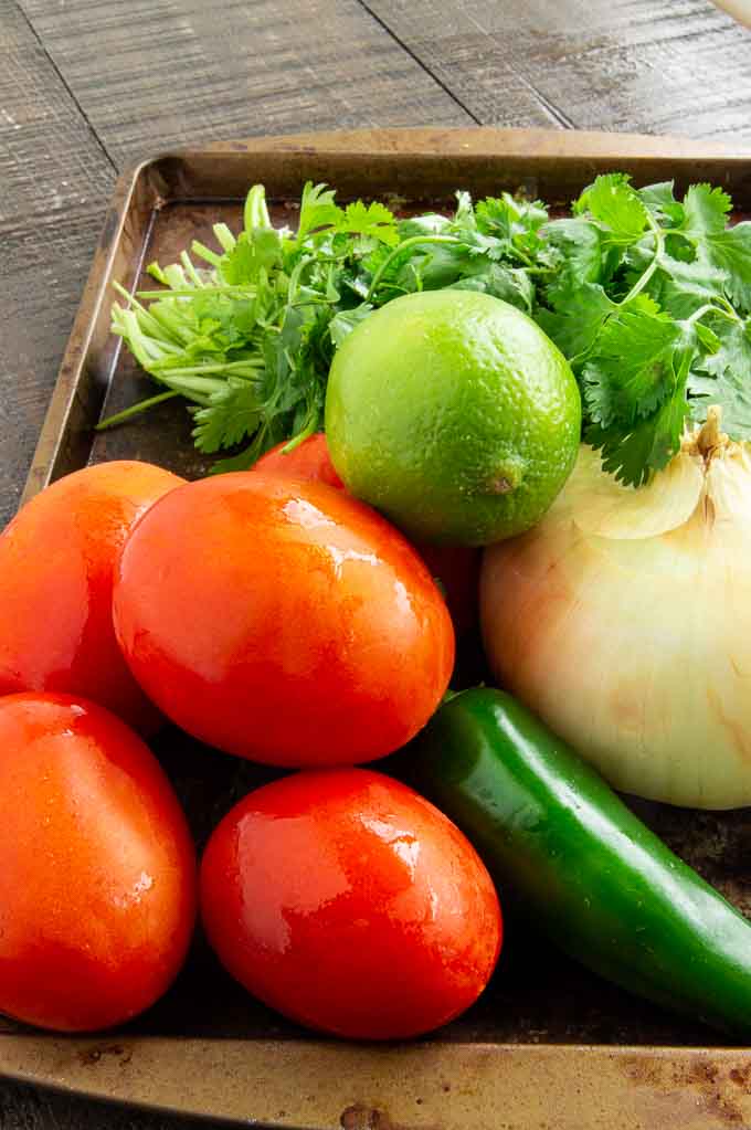 tomatoes, lime, onion, cilantro and chilis for salsa fresca