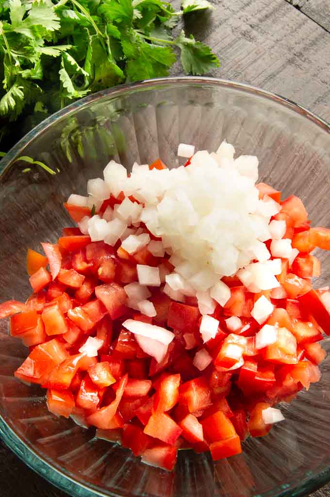 diced onions and tomatoes in a bowl for pico di Gallo