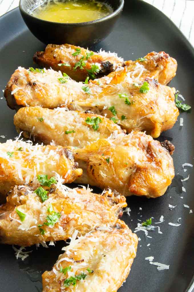 Plate of chicken wings with parmesan garlic dipping sauce