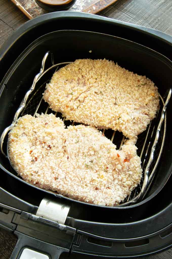 breaded pork schnitzel in the air fryer ready to cool