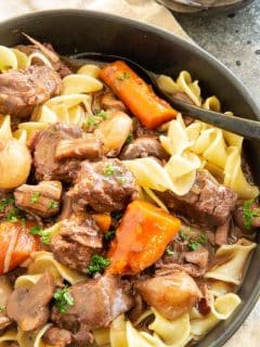 black plate with French beef stew spooned over the top