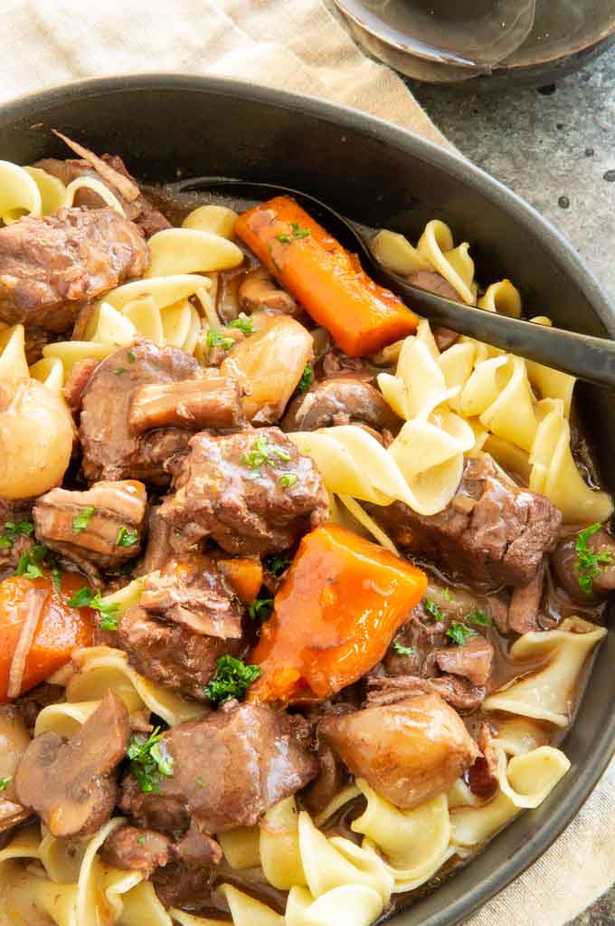black plate with French beef stew spooned over the top
