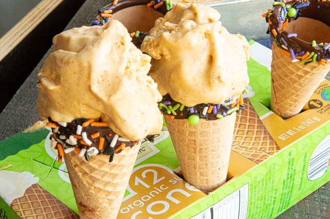 Pumpkin ice cream in chocolate sprinkle dipped cones