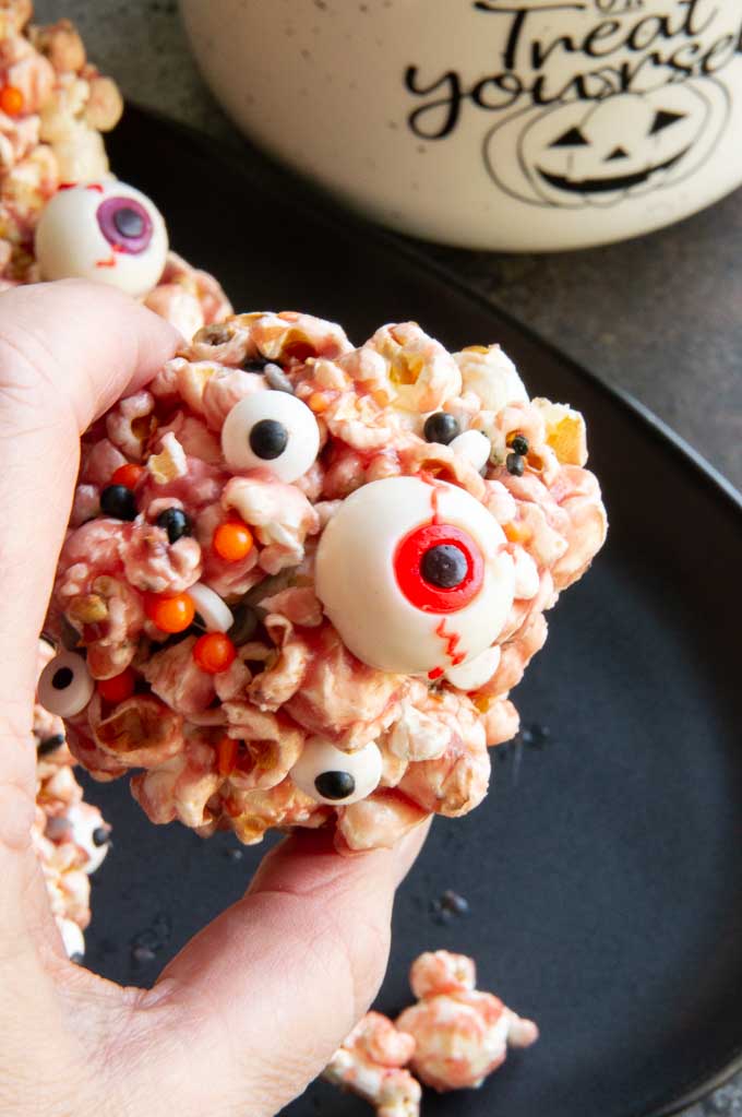 holding a creepy eyeball aka popcorn ball