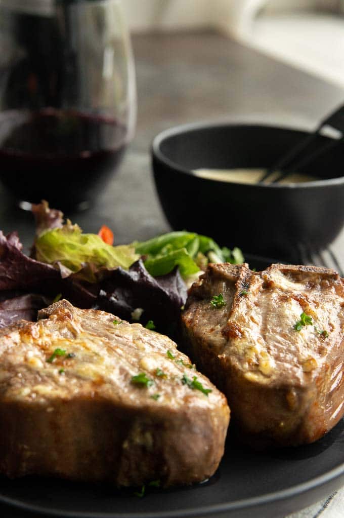 two thick lamb chops made in the air fryer on a black plate