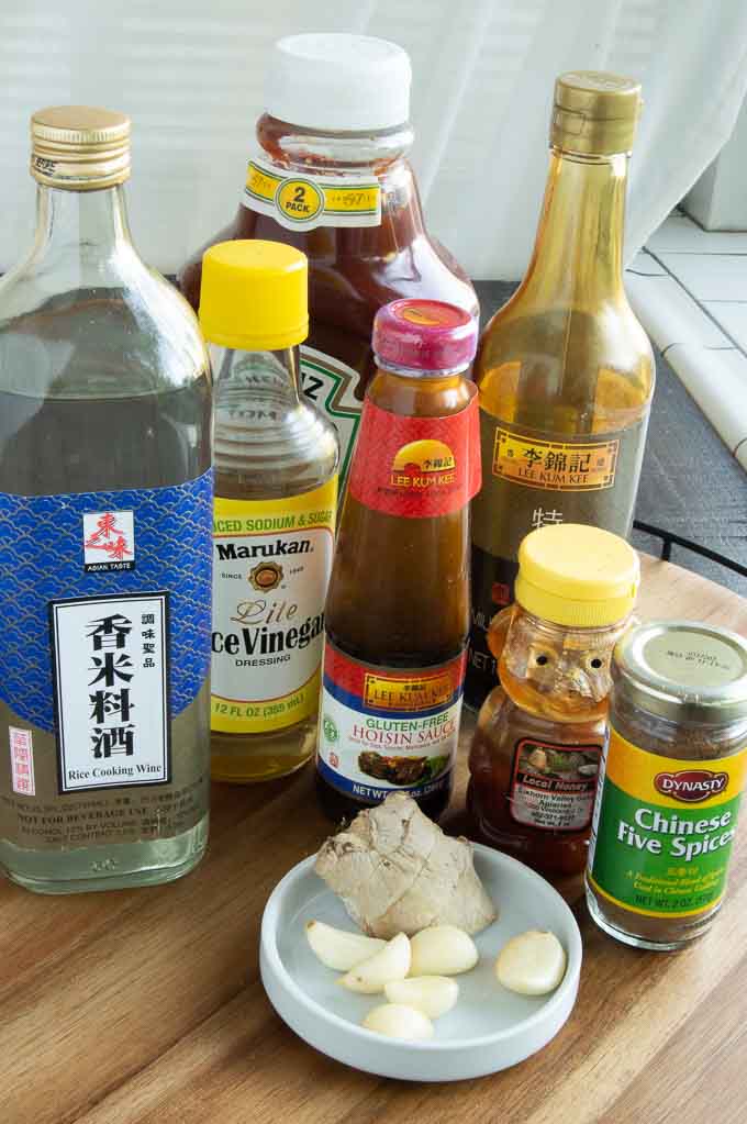 Chinese rice wine, rice wine vinegar, ketchup, soy sauce, garlic, ginger, chinese 5 spice and hoisin sauce on a tray