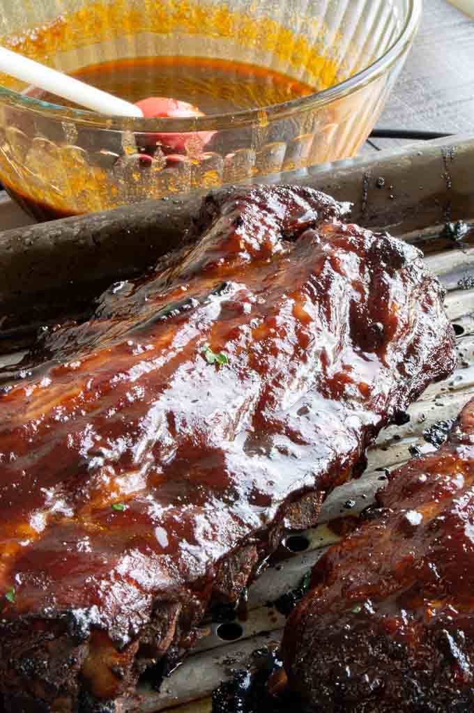brushing spare ribs with chinese bbq sauce