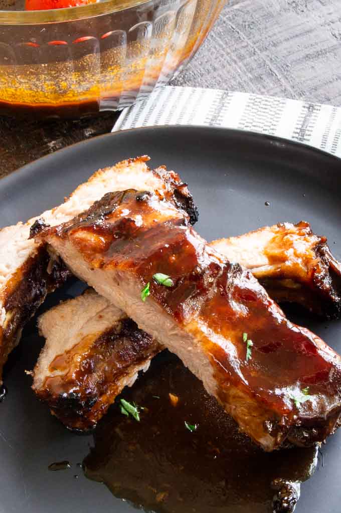 sliced chinese ribs on a plate with a sticky sauce