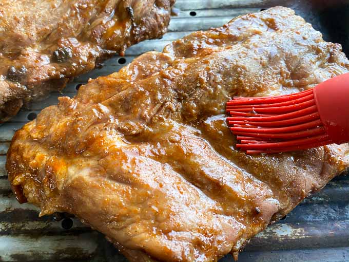 basting the pork ribs with chinese bbq sauce