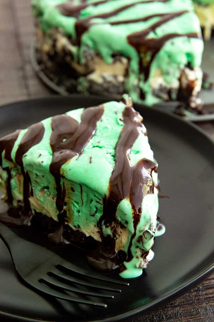 Slice of Grasshopper pie on a black plate on a table