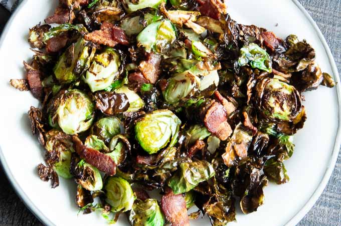 Crispy, roasted brussel sprouts on a white plate