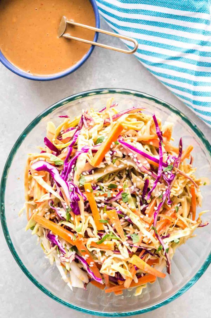 bowl of cabbage slaw with side of dressing