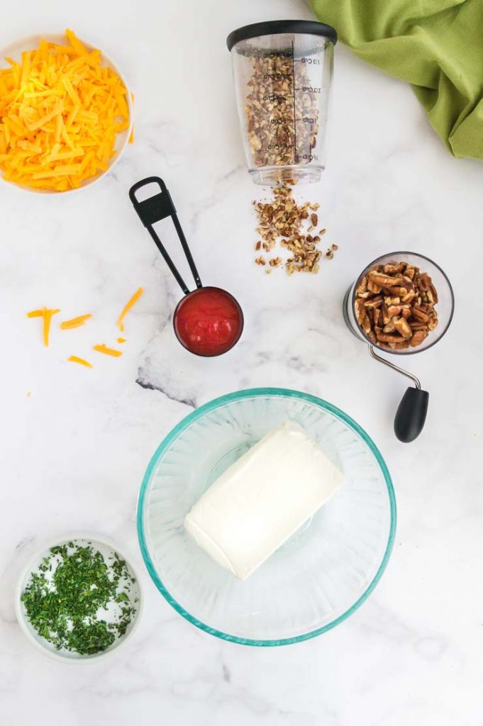 All ingredients to make a cheese ball with buffalo sauce cheese spread