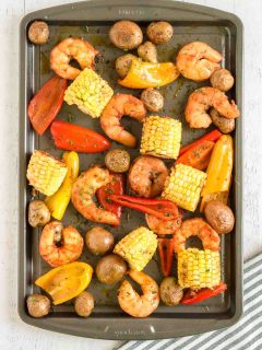tossing shrimp and veggies on the tray
