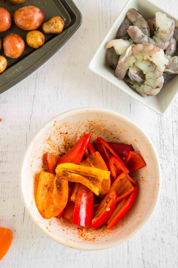 tossing peppers with seasoning