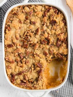 baking dish with sweet potato hot dish topped with pecans