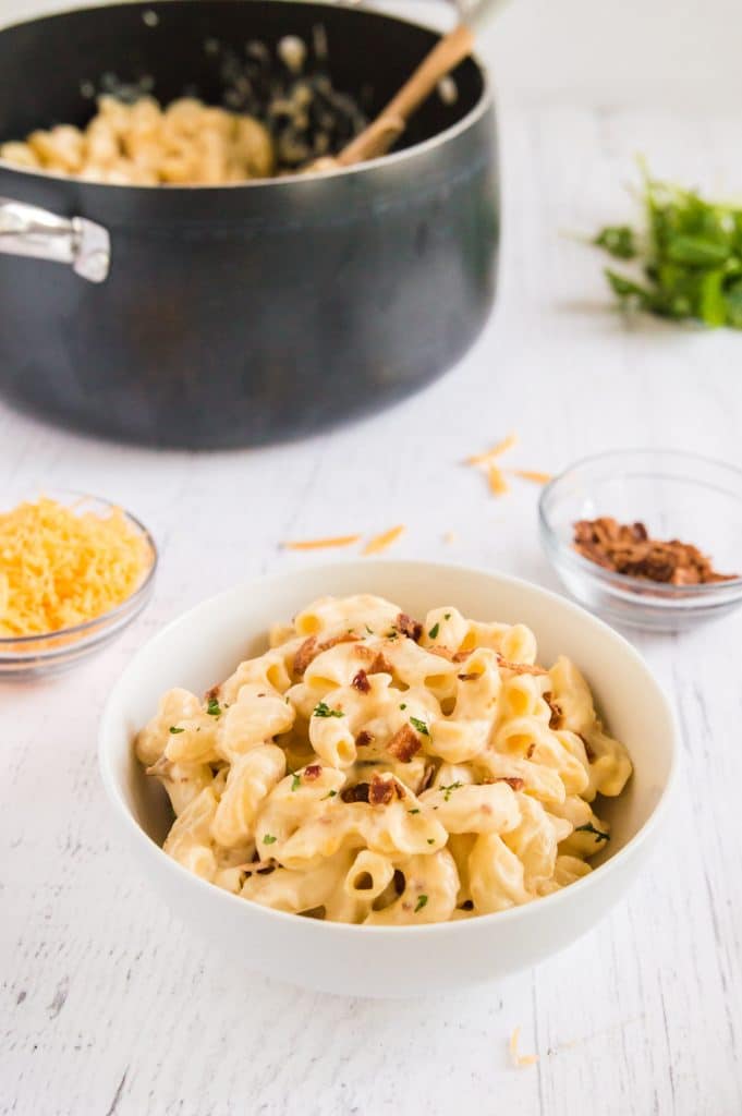 buffet table serving pasta with bacon and cheese