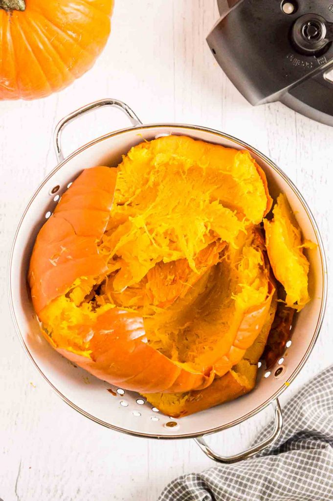 pressure cooked pumpkin draining in a colander