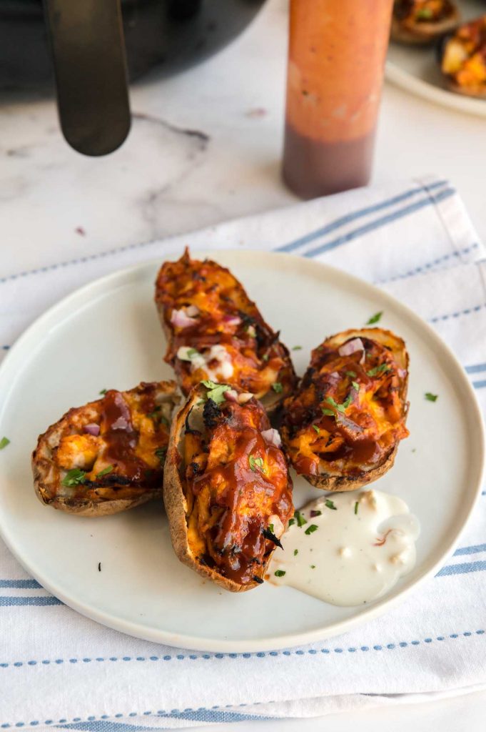 potato skins on an appetizer plate loaded with bbq chicken