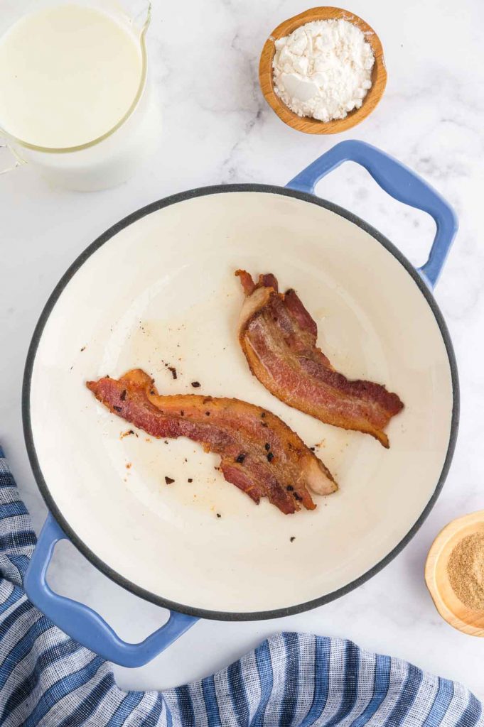 bacon in a pan cooking