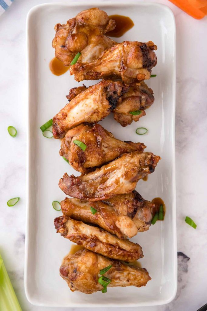 serving dish stacked with teriyaki wings