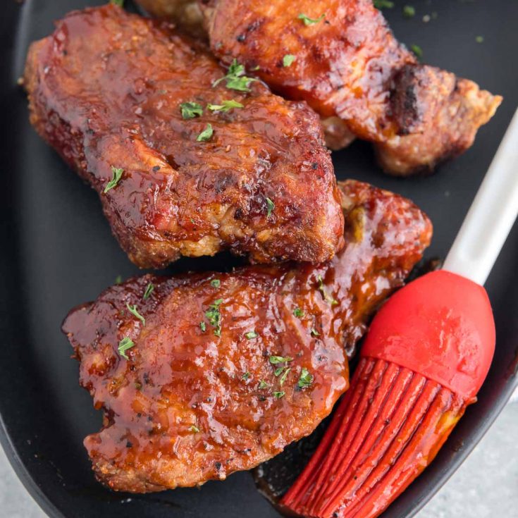 air fryer ribs on a plate with bbq sauce