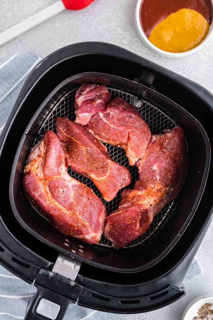 uncooked ribs in the base of the air fryer