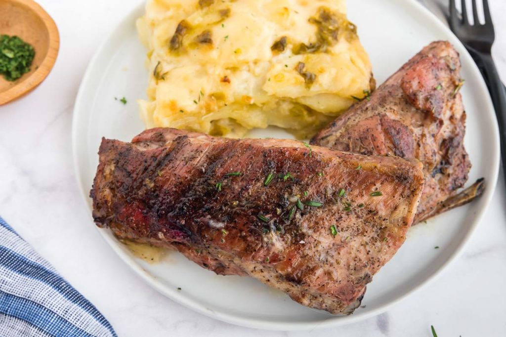 2 ribs on a plate with scalloped potatoes