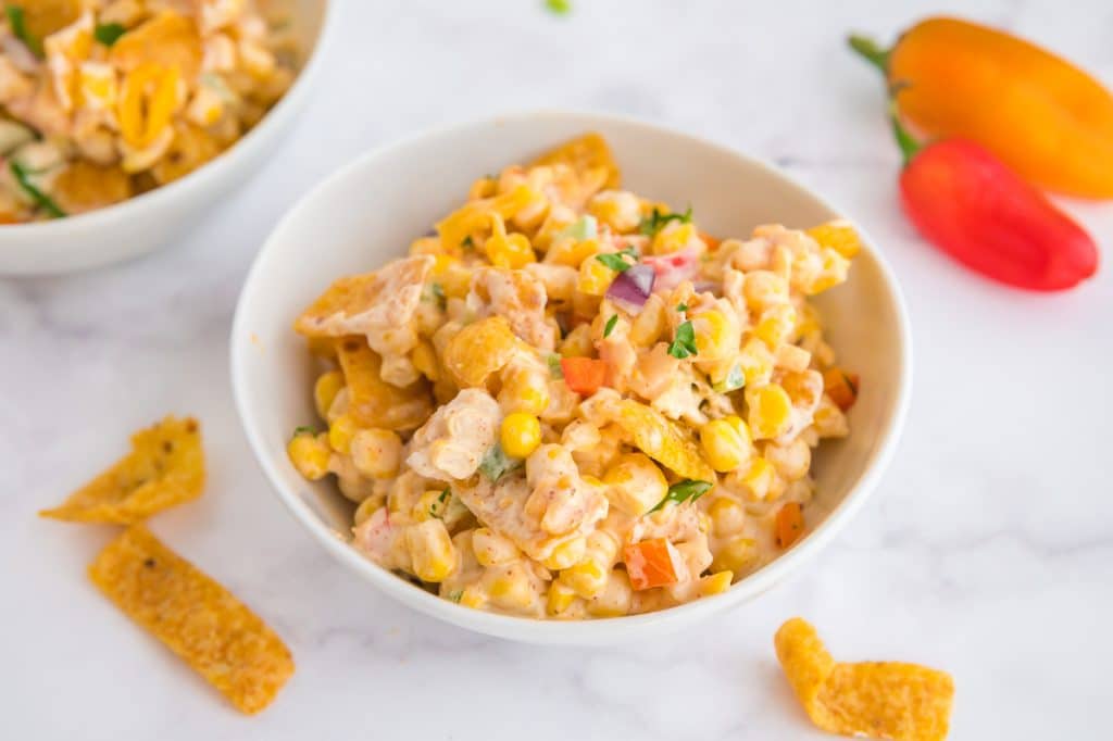 serving bowl full of corn salad topped with Fritos