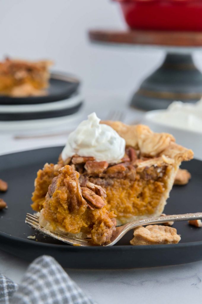 a spoonful of pecan sweet potato pie next to a lslice of pie 